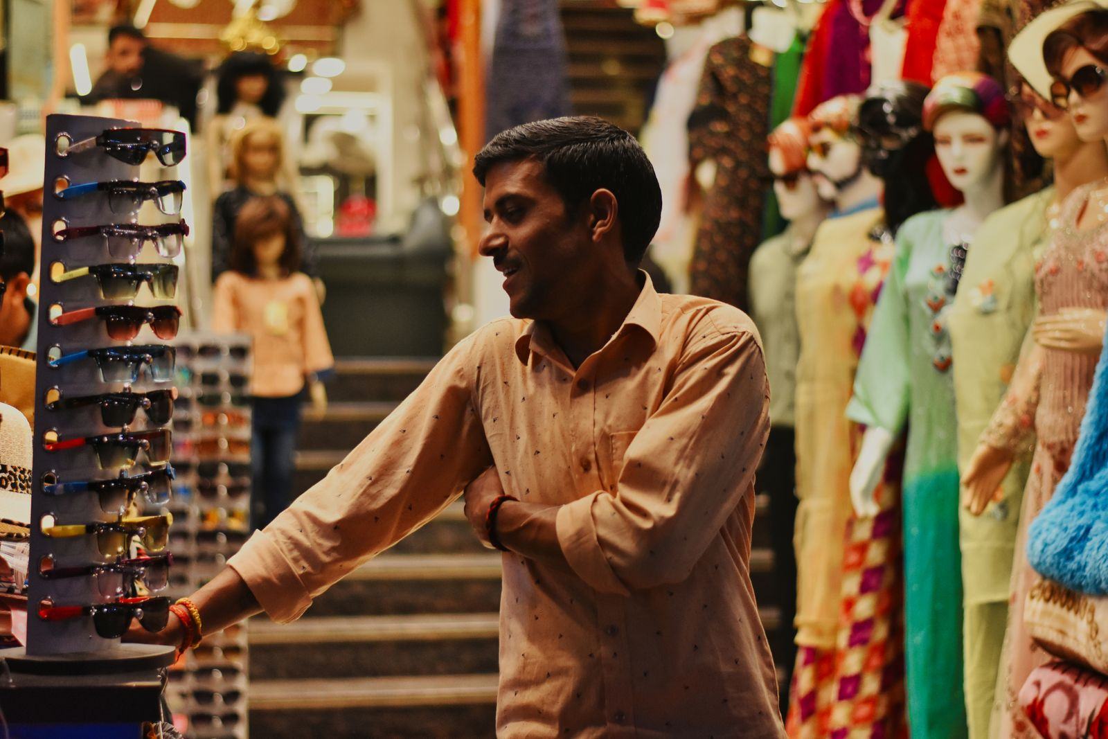 A smiling shop owner in his clothing store