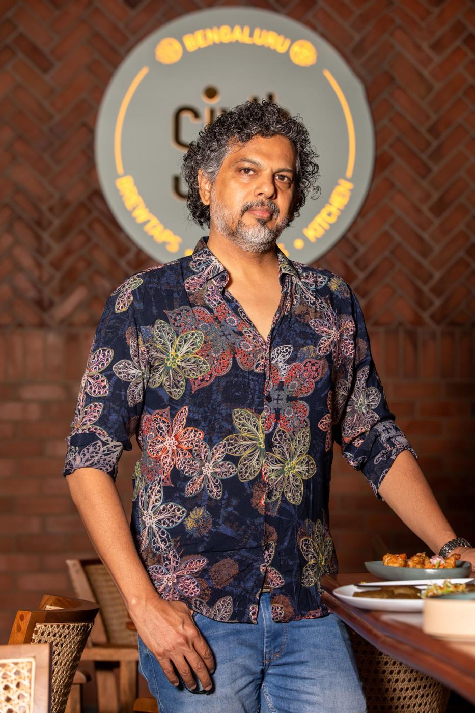 A restaurant owner standing at his restaurant in Bengaluru
