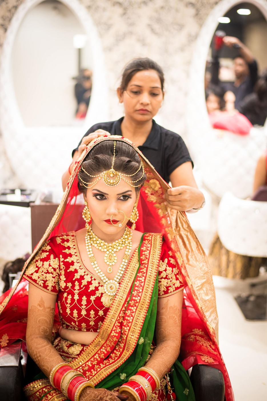 A stylist preparing a bride at a beauty salon